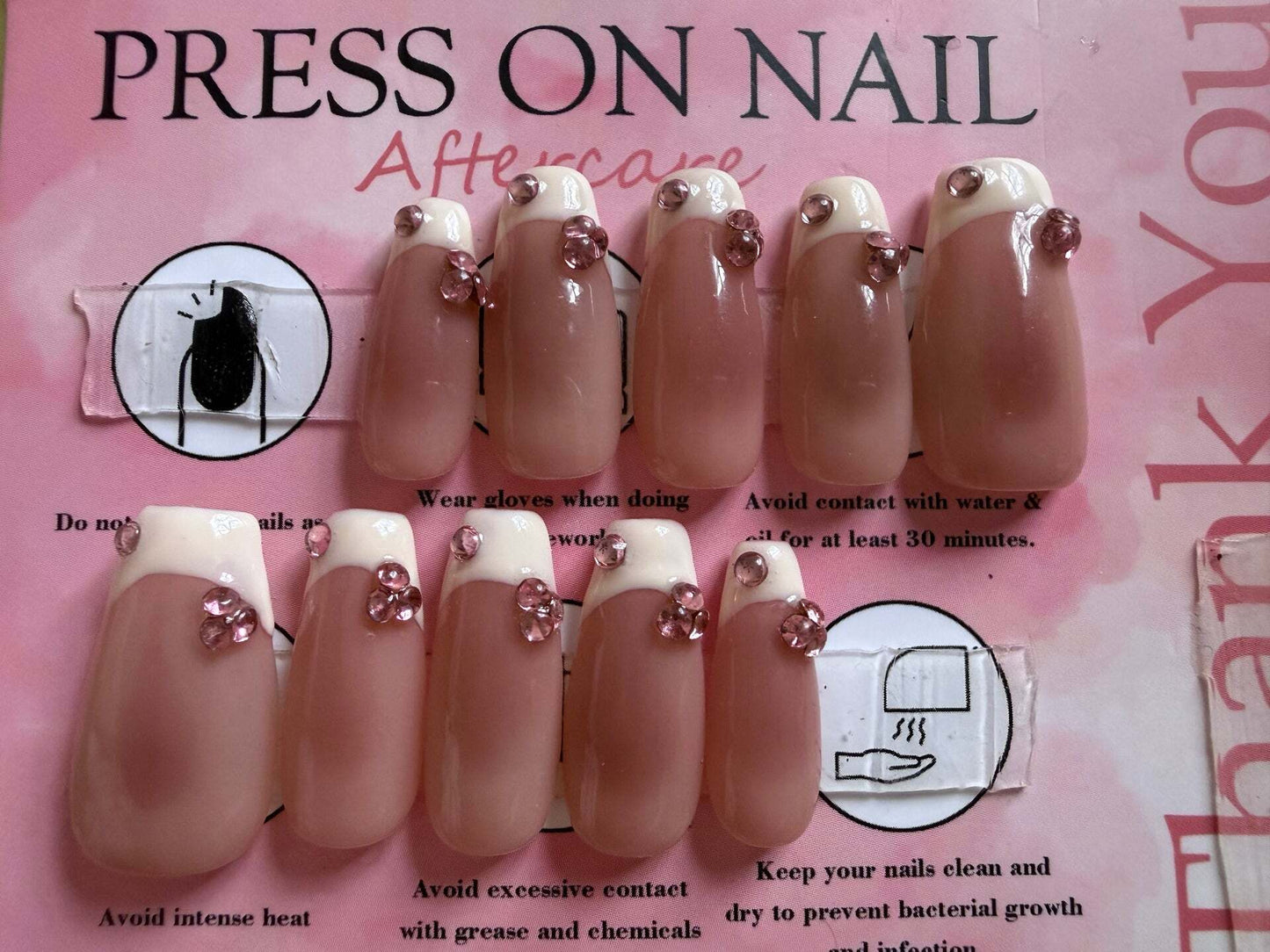 Pink french tip press-on nails with pink rhinestone clusters