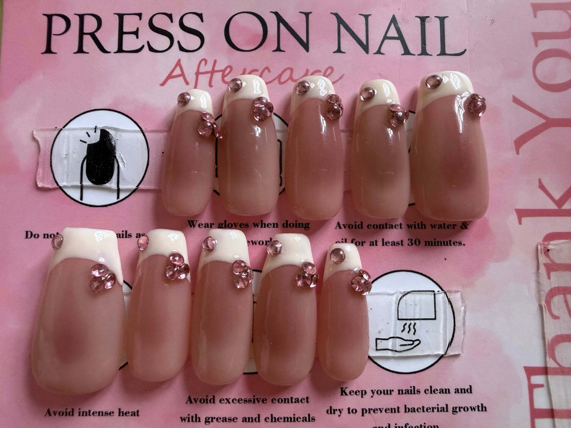 Pink french tip press-on nails with pink rhinestone clusters